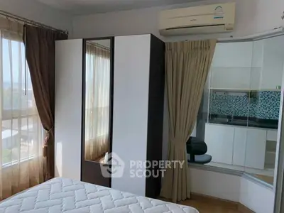 Modern bedroom with large windows and air conditioning unit