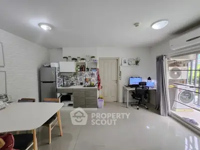 Modern open-plan kitchen and study area with sleek design and natural light.