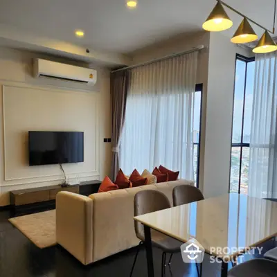 Modern living room with city view, featuring elegant decor and natural light.