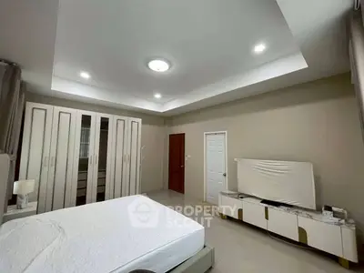 Spacious bedroom with modern furniture and ample closet space