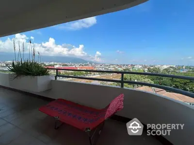 Spacious balcony with stunning city and mountain views, perfect for relaxation.