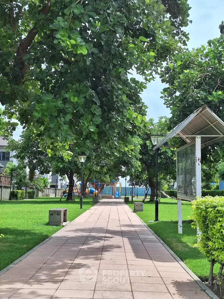 Charming garden pathway with lush greenery and playground, perfect for family-friendly living.