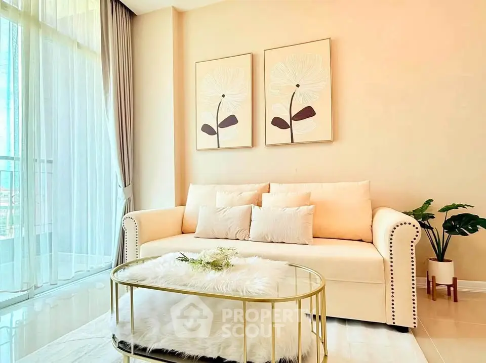Bright and elegant living room with plush sofa and chic decor, perfect for relaxation and entertaining.