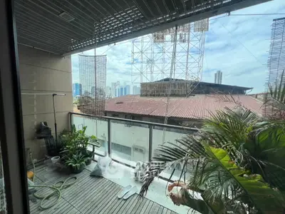 Spacious balcony with city view and lush greenery