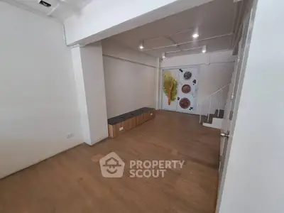 Spacious interior with wooden flooring and modern lighting, ideal for versatile use.