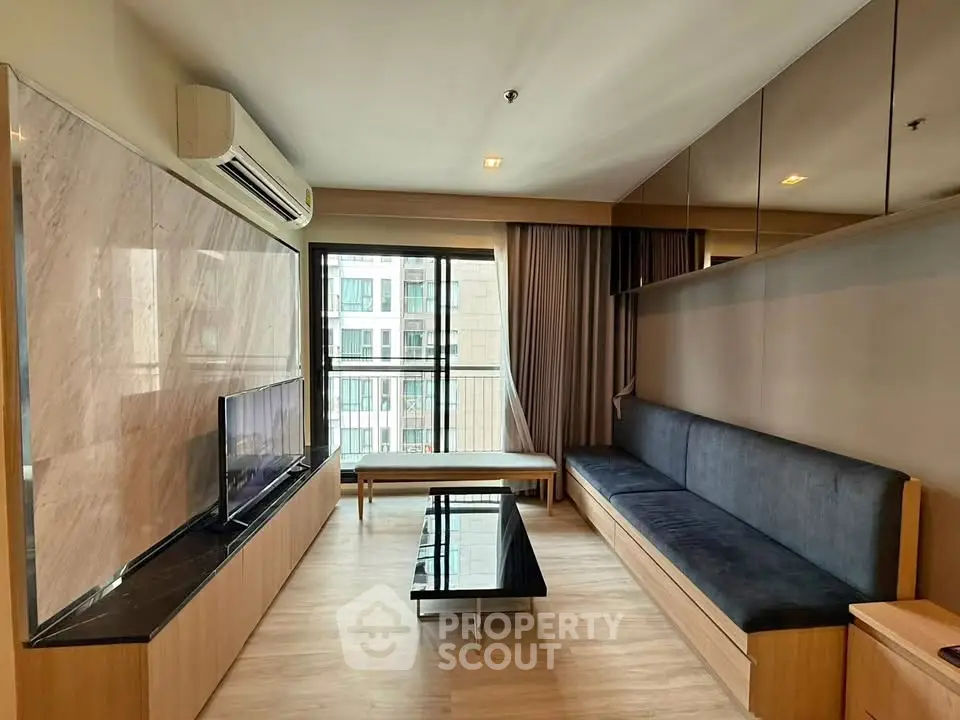 Modern living room with sleek design and large window offering city view