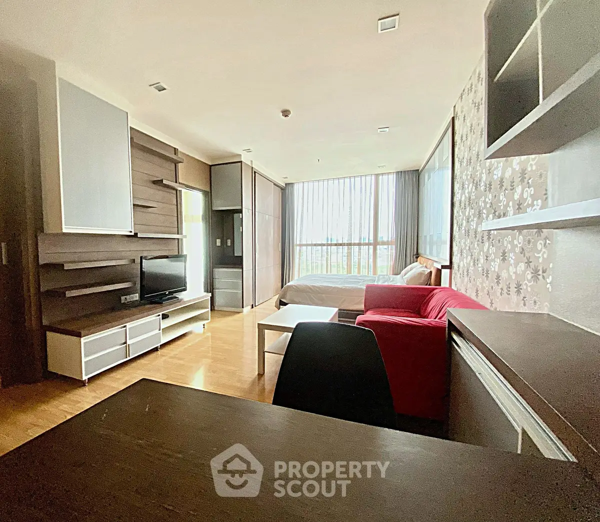 Spacious studio apartment with modern decor and large windows
