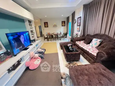 Spacious living room with plush brown sofa and modern entertainment setup