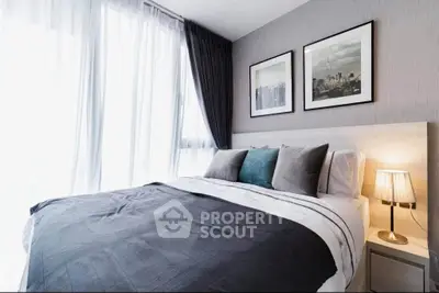 Modern bedroom with stylish decor and large windows for natural light