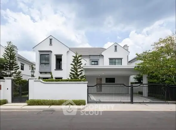 Stunning modern white house with sleek design and spacious driveway in a serene neighborhood.