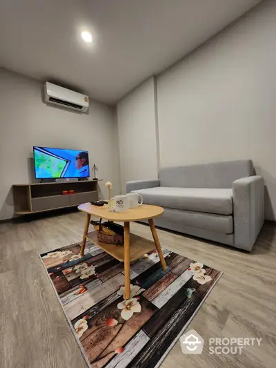 Modern living room with cozy sofa and stylish decor, perfect for relaxation and entertainment.