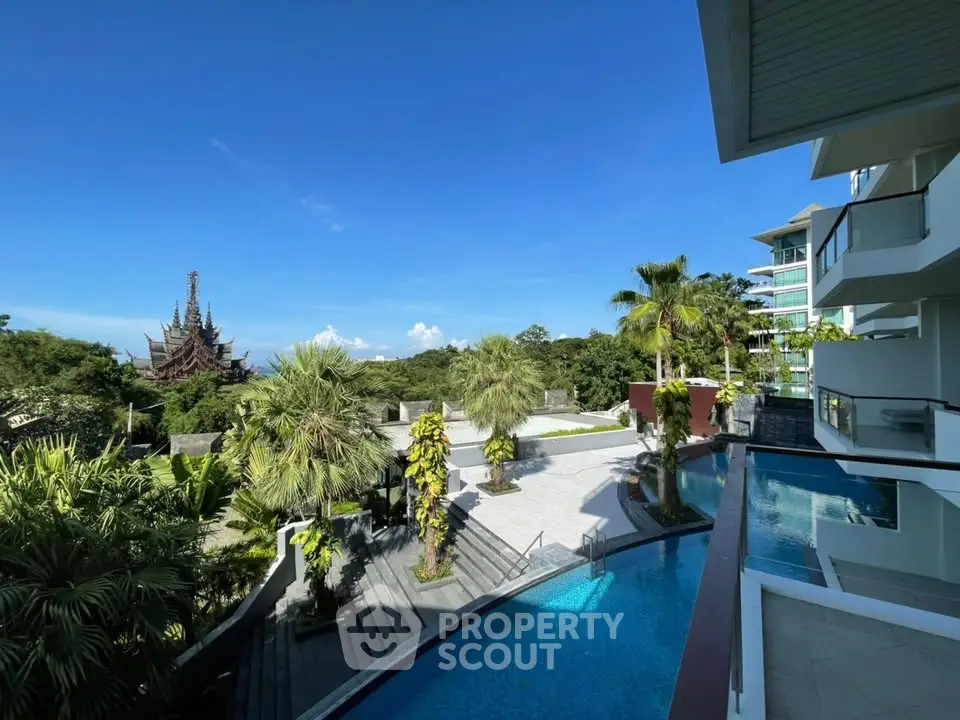 Luxurious condo with stunning pool and lush greenery offering breathtaking views of iconic architecture.