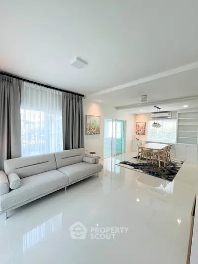 Spacious modern living room with elegant dining area and natural light