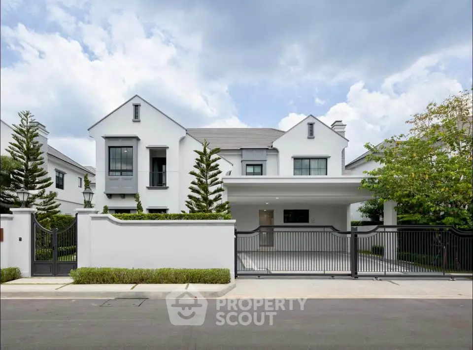 Elegant modern house with spacious driveway and lush greenery, perfect for luxury living.