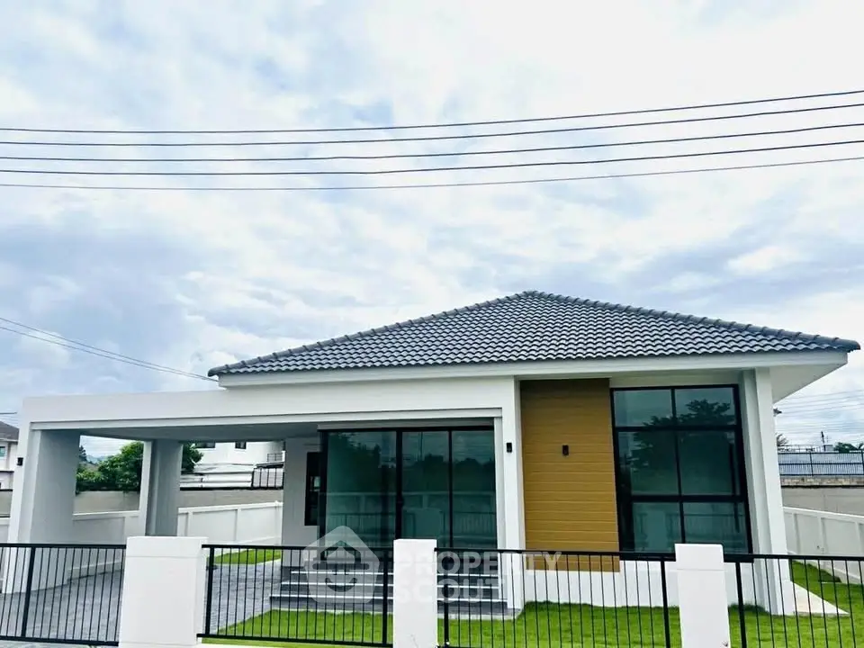 Modern single-story house with sleek design and spacious yard