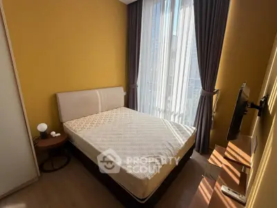 Cozy bedroom with modern furnishings and large window for natural light