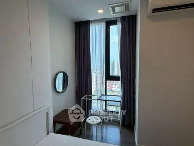 Modern bedroom with floor-to-ceiling window offering stunning city views, featuring minimalist furniture and elegant curtains.
