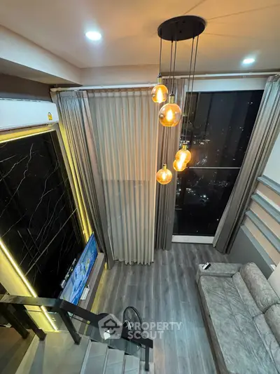 Luxurious modern living room with high ceilings, elegant lighting, and stunning city view from large windows.