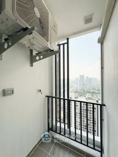 High-rise balcony with city view and air conditioning unit, perfect for urban living.