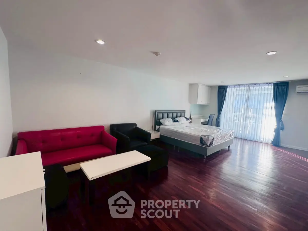 Spacious studio apartment with modern furnishings and hardwood floors