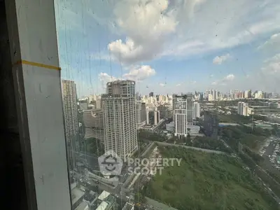 Stunning cityscape view from high-rise building window showcasing urban skyline.