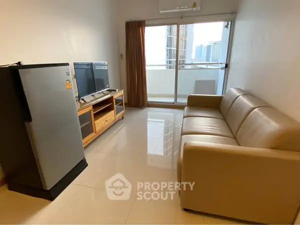 Modern living room with balcony view, featuring sleek furniture and natural light.