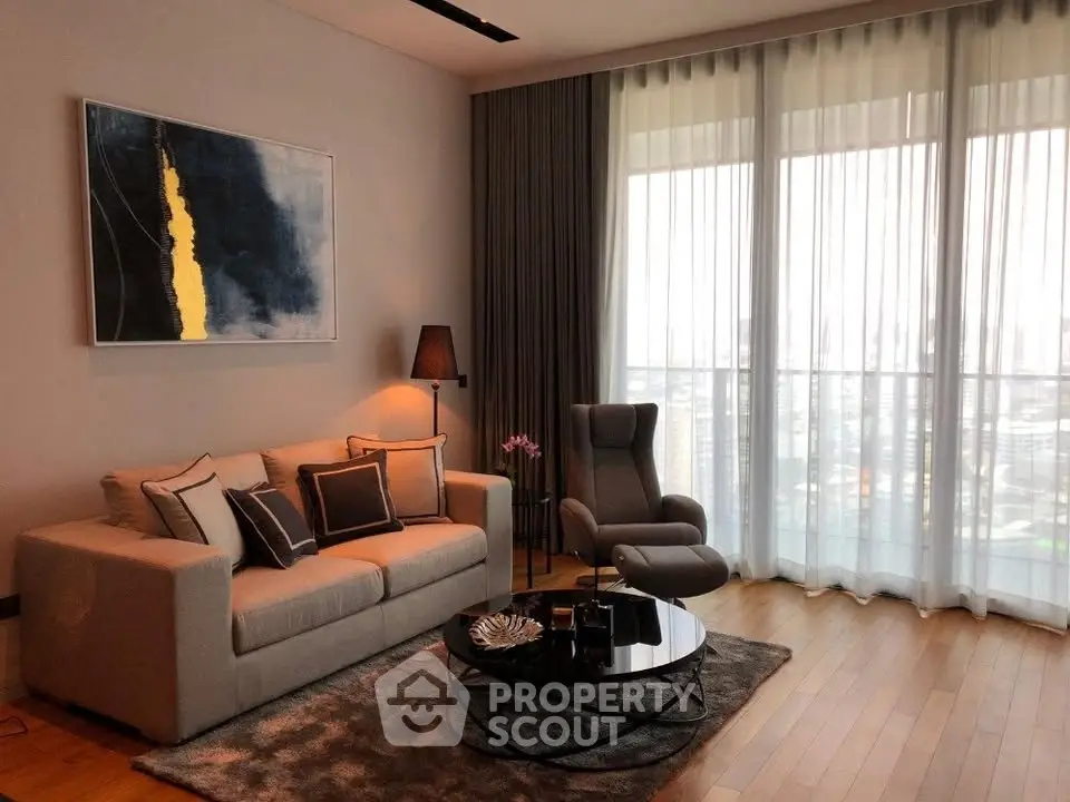 Stylish living room with modern decor and large windows offering city views.