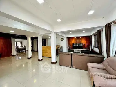 Spacious open-plan living room with modern furnishings and ample natural light.