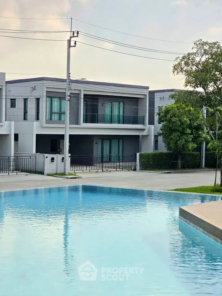 Modern townhouse with pool view in a serene neighborhood setting.