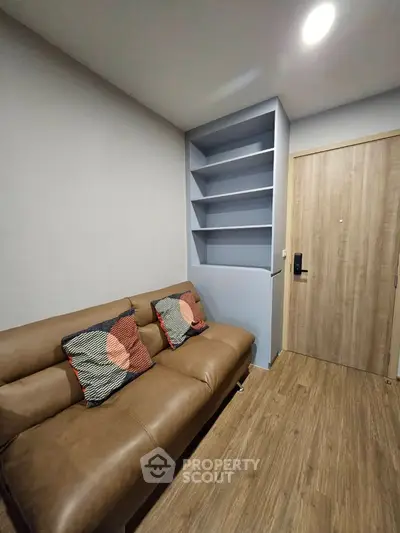 Modern living room with stylish sofa and built-in shelves