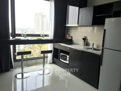 Modern kitchen with sleek cabinetry and city view from window