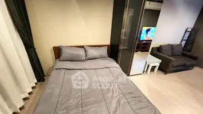 Modern bedroom with cozy gray bedding and stylish living area