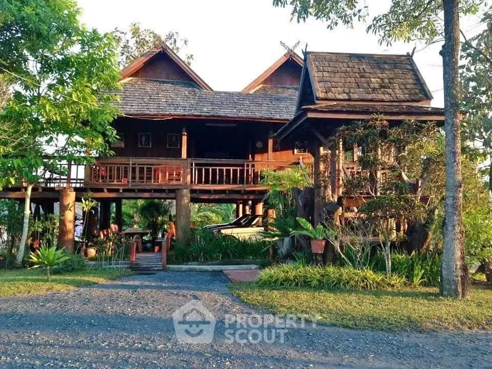 Charming traditional wooden house with lush garden and elevated design.