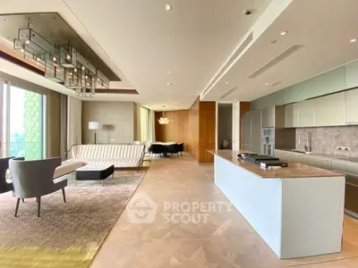 Luxurious open-plan living room and kitchen with modern design and elegant furnishings.