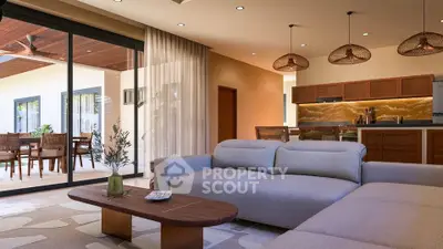 Luxurious open-plan living room with modern kitchen and stylish decor, perfect for entertaining.
