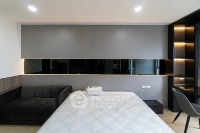 Modern bedroom with sleek design, featuring a cozy bed and stylish sofa, perfect for urban living.