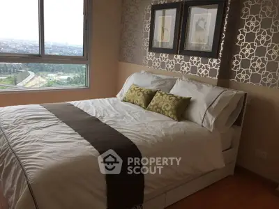 Elegant bedroom with large window offering stunning city view and stylish decor.