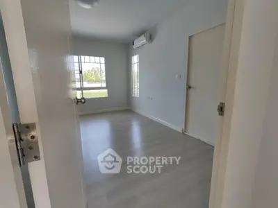 Spacious unfurnished bedroom with large windows and air conditioning