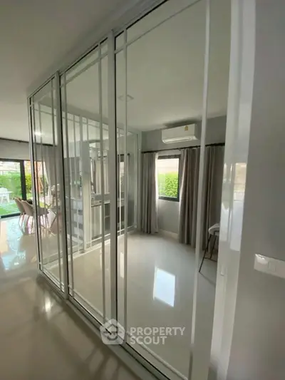 Modern interior with glass sliding doors and air conditioning in a bright living space.
