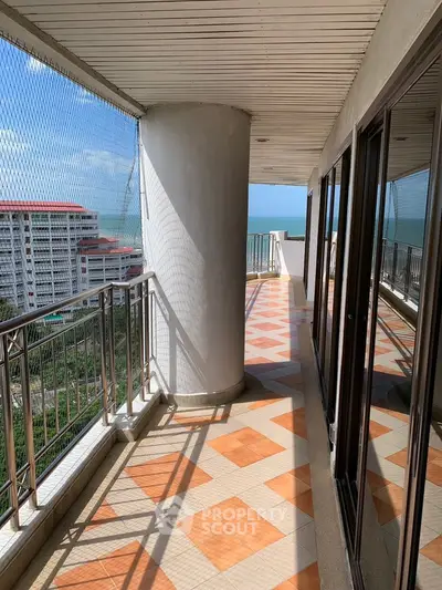 Spacious balcony with ocean view in modern high-rise building