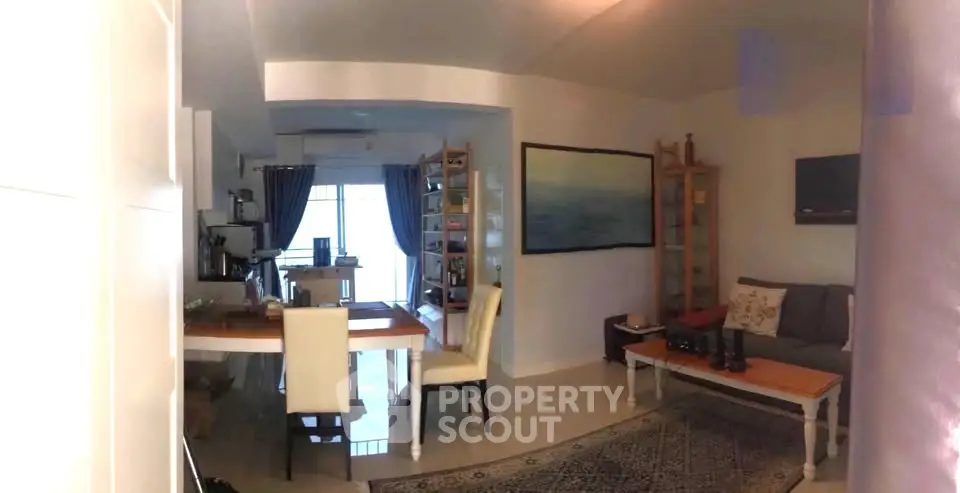 Spacious living room with elegant decor and dining area, perfect for modern living.