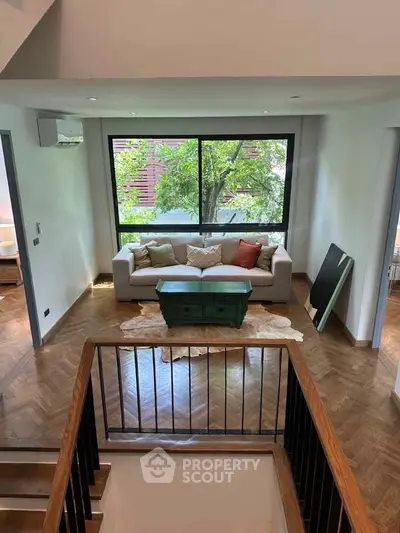 Spacious living room with large window and stylish decor in modern home