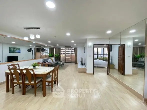 Spacious open-plan living and dining area with modern decor and ample natural light.