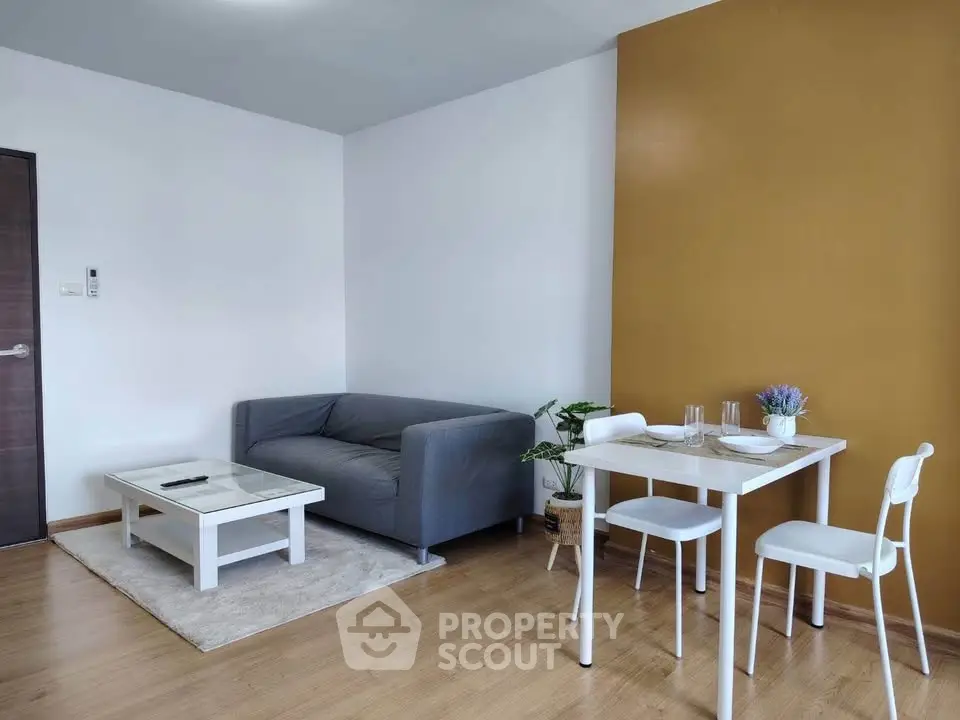 Modern living room with cozy gray sofa and stylish dining area