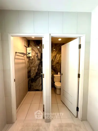 Modern bathroom with separate shower and toilet areas, featuring elegant tile design.