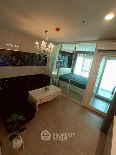 Luxurious living room with elegant chandelier and mirrored wardrobe in modern apartment