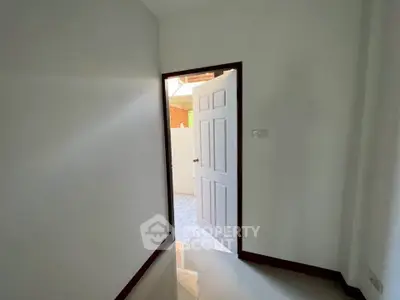 Bright room with open door leading to a tiled outdoor area, showcasing potential for customization.