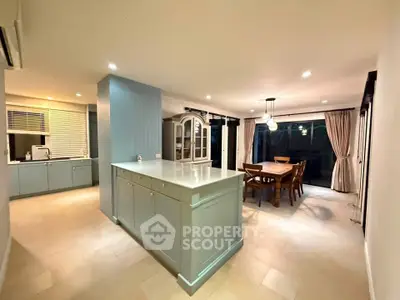 Spacious open-layout kitchen and dining area with modern design and ample natural light.