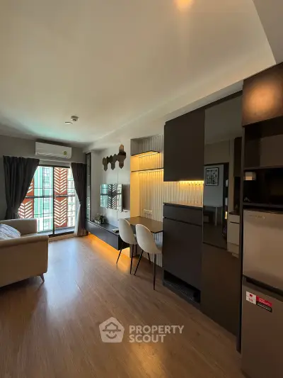 Modern living room with stylish decor and natural light in a contemporary apartment.