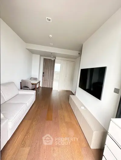Modern living room with sleek TV setup and minimalist furniture design